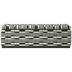 an upholstered bench with black and white checkered fabric on the back,