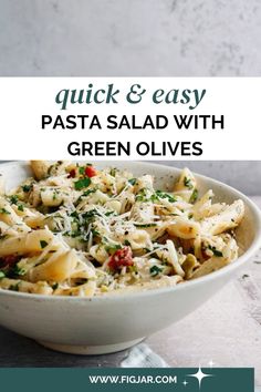 pasta salad with green olives in a white bowl