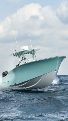 a white and blue boat in the ocean with two people on it's back