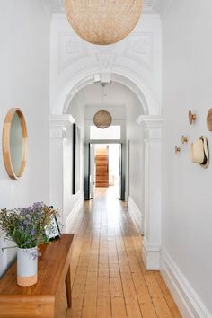 the hallway is clean and ready for guests to use it as an entrance way in this house