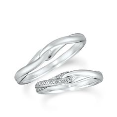 two white gold wedding rings with diamonds on each side and an open band in the middle