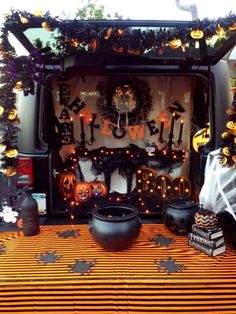 the back of a van decorated for halloween with pumpkins and jack - o'- lanterns