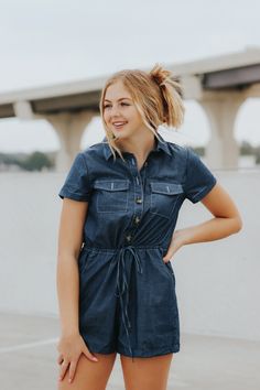 Short sleeve button detail denim chambray romper.Brooklin is wearing a size smallLightweight chambray denimAdjustable waist drawstring & button down topThis item is final sale. Denim Blue Cotton Button-up Jumpsuits And Rompers, Casual Short Sleeve Denim Jumpsuit With Buttons, Button-up Denim Jumpsuit For Day Out, Denim Button-up Jumpsuit For Day Out, Cotton Denim Jumpsuit With Button Closure For Day Out, Dark Wash Cotton Button-up Jumpsuits And Rompers, Casual Dark Wash Short Sleeve Jumpsuits And Rompers, Dark Wash Denim Jumpsuit For Day Out, Casual Medium Wash Button-up Jumpsuits And Rompers