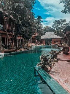 an outdoor swimming pool surrounded by trees