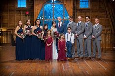 a group of people standing on top of a wooden floor in front of a window