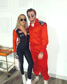 a man and woman dressed up in racing gear posing for a photo with glasses on