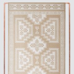 a beige and white rug with an intricate design