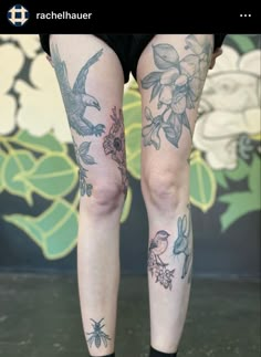 a woman's legs with tattoos and flowers on them