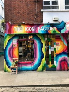 a colorful building with the words the icon factory painted on it's front door