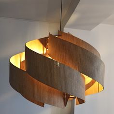 a lamp hanging from the ceiling in a room with white walls and wood trimmings