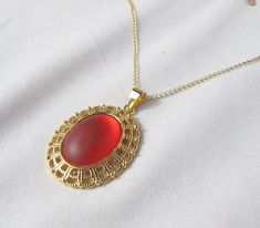 "This bright cherry red pendant is perfect for Christmas, but you don't have to wait till then to wear it! The chain is long enough to wear over cowl-neck sweaters, but the necklace is a nice light weight and won't pull you down! The settings is a sparkling fancy gold two-tier filigree. The photos don't do it justice, as the cabochon catches the light with a soft glow! Necklace Length: 30\" with 2\" extension Pendant Length: 1.75\" Pendant Width: 1.25\" Featured bead: Lunasoft 25x18mm cherry oval cabochon Clasp: Lobster claw To make this necklace, I glued the cabochon onto the setting and let it cure. Then I threaded the chain through the bail. This is a simple pendant, but is large enough to look good on a bulky sweater! Perfect for Winter, Spring and Fall...and maybe even Summer!" Elegant Red Locket Necklaces, Elegant Red Necklace With Large Pendant, Red Locket Necklace For Formal Occasions, Red Necklace With Large Pendant For Formal Occasions, Formal Red Necklace With Large Pendant, Red Locket Necklace With Round Pendant, Red Locket Necklace For Jewelry Making, Red Pendant Necklace For Christmas, Glow Necklace