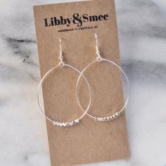 These big beaded hoops in gold or silver are the perfect simple statement — just right for those busy mornings when finding something that matches your outfit is just too much to ask. stainless steel ear wire and hand-shaped hoop with faceted beads choose gold-plated or silver-plated lead-free and nickle-free plastic earring back 2.5" long and 1.5" wide (each pair is handmade so sizes can vary slightly) packaged on a kraft earring card in a clear resealing bag Hoop Earrings Big, Gifts For Girlfriends, Plastic Earrings, Earrings Big, Dangle Hoop Earrings, Mini Hoop Earrings, Chunky Beads, Rainbow Beads, Earring Cards