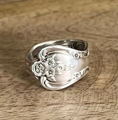 a silver ring sitting on top of a wooden table