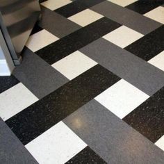 a black and white checkered floor with a refrigerator