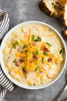 a bowl of potato soup with cheese and bread