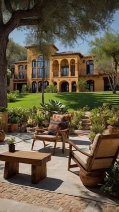 two wooden chairs sitting on top of a stone patio