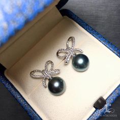 Highline: Beautiful Diamond Bow Product Information OriginTahitian Pearl Jewelry Processed in Japan MaterialTahitian Pearl, 18k White Gold and Diamond Dimensions1.3 x 1.8 cm Pearl Shaped: Round Size: 9-10mm Quality: AAAA Nacre: Very Thick Color: Platinum Grey Luster: Very High Accessories Metal: 2.7g of 18k White Gold Other: 0.46ct of SI Quality Natural Diamond Luxury Tahitian Pearl Earrings For Anniversary, Luxury Tahitian Pearl Earrings For Gift, Luxury Tahitian Pearl Earrings Gift, Luxury Tahitian Pearl Wedding Earrings, Luxury Black Pearl Earrings Gift, Luxury Black Pearl Earrings For Gift, Luxury Tahitian Pearl Drop Jewelry, Luxury Tahitian Pearl Earrings In White Gold, Luxury Tahitian Pearl Earrings