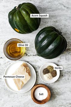 the ingredients for an acorn squash recipe on a marble surface