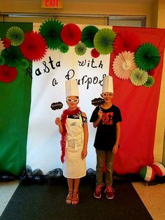 two children standing next to each other in front of a sign that says pasta with a dipper