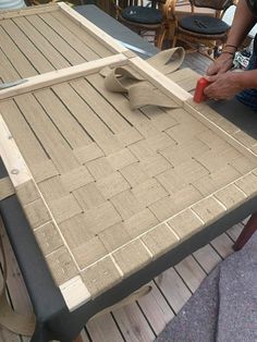 a person sanding down a table that has been made out of wood planks