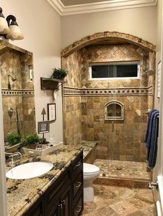 a bathroom with two sinks, a toilet and a walk - in shower next to each other