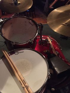 drums and sticks are sitting on the floor