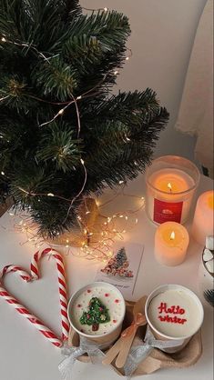 christmas decorations and candles are on the table