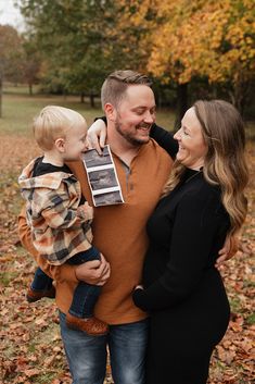 a man and woman holding a baby boy in their arms