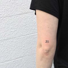 a person with a small tattoo on their left arm and the number twenty two behind them