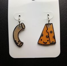 a pair of earrings with cheese on them