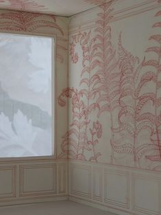 the corner of a room with a window and wallpaper on it, painted in red