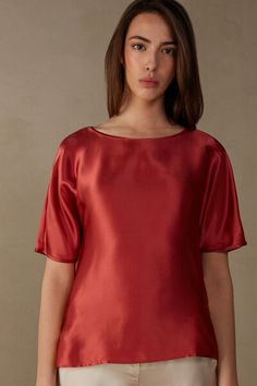 Kimono cut top with short, elbow-length sleeves and rounded boat neckline. The front is in pure silk satin and the back is in soft modal. Side vents. Loose fit.
The model is 5’ 9” (175 cm) tall and is wearing a size 2 / S.

The silk in this piece is bluesign® certified. Elegant Short Sleeve T-shirt For Evening, Elegant Evening Top With Wide Neckline, Sleek Short Sleeve Summer Tops, Elegant Short Sleeve Tops For Evening, Elegant Silk Crew Neck Top, Formal Satin Blouse With Short Sleeves, Formal Short Sleeve Satin Blouse, Elegant Short Sleeve Evening Tops, Summer Satin Short Sleeve Blouse