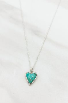 Treat yourself to a little extra sparkle with this beautiful Turquoise and Silver Heart Necklace. Featuring a striking turquoise heart shaped pendant with a glittering silver trim, this look is sure to become your go-to for everyday glam. Love it 'til your heart's content!Details: Handmade Turquoise Heart Pendant Sterling Silver Chain Approximate Dimensions: Length: 17.5" Heart Pendant: 0.5" x 0.5" Everyday Glam, Sterling Silver Heart Necklace, Heart Shaped Pendant, Turquoise Heart, Silver Heart Pendant, Silver Heart Necklace, Heart Shape Pendant, Sterling Silver Heart, Turquoise Earrings