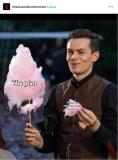 a man holding a pink lollipop with the words the plan on it