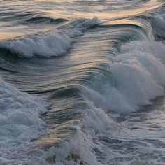 the ocean waves are rolling in to shore