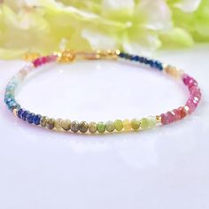 Add a touch of sparkling elegance to your outfit with this exquisite Multi Tourmaline Dainty Bracelet. Each tiny 2X3mm faceted gemstone is carefully handcrafted to create a stunning piece of handmade jewelry. Perfect as a birthstone gift for a loved one, this minimalist bracelet not only exudes beauty but also carries the power of crystal healing and protection. Elevate your style and energy with this gorgeous accessory. Tourmaline Cube size: 2X3MM Completely natural genuine gemstones measure di Adjustable Faceted Bohemian Crystal Bracelet, Adjustable Faceted Crystal Bohemian Bracelet, Bohemian Adjustable Faceted Crystal Bracelet, Dainty Adjustable Faceted Bracelet, Adjustable Faceted Crystal Bracelet In Minimalist Style, Delicate Adjustable Bracelet With Faceted Beads, Delicate Adjustable Faceted Bracelet, Minimalist Adjustable Faceted Crystal Bracelet, Adjustable Dainty Crystal Bracelet With Faceted Beads