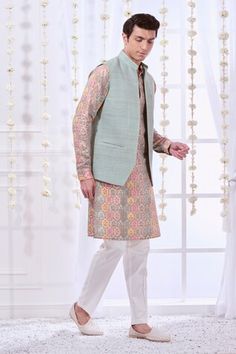 Cloud blue sleeveless bundi with mandarin collared neckline. Paired with mughal print kurta and pant. - Aza Fashions Designer Sleeveless Kurta For Spring, Festive Nehru Jacket With Stand Collar For Spring, Sleeveless Bandhgala For Eid, Sleeveless Nehru Jacket For Spring Wedding, Sleeveless Nehru Jacket For Diwali, Fitted Sleeveless Kurta For Spring, Spring Fitted Sleeveless Kurta, Fitted Multicolor Nehru Jacket For Spring, Fitted Sleeveless Nehru Jacket For Transitional Seasons