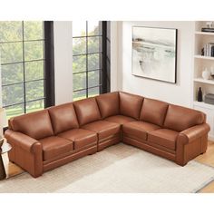 a brown leather sectional sofa in a living room