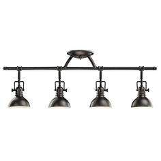 three lights are hanging from the ceiling in an industrial style light fixture with metal shades