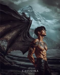 a man with tattoos standing in front of a mountain and holding a dragon's wings