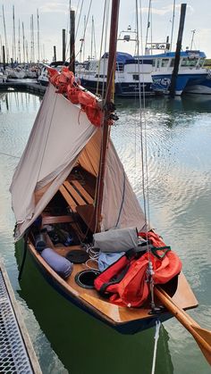 a small sailboat is docked in the water