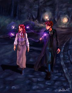 two people walking down a path in the woods at night with glowing lights on their hands