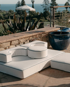 A modular lounge seating arrangement with crisp white cushions and navy piping, perfect for relaxing by the pool or hosting outdoor gatherings. Keywords: modular outdoor seating, luxury patio decor, poolside lounge, outdoor entertaining, navy and white design. Pillow Lounger, Commercial Umbrellas, Cooler Tote Bag, Umbrella Shop, Cozy Outdoor, Quiet Area, Beach Shop