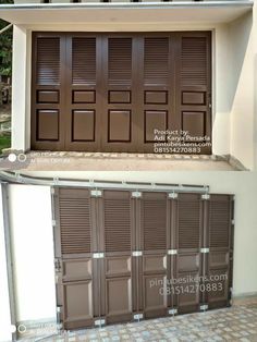 two garage doors with brown shutters on each side and the same one in front