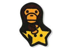 a black and yellow sticker with a monkey on it's head holding a star