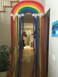 a hallway decorated with rainbow streamers and flowers