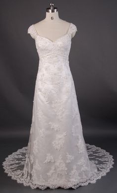 a white wedding dress on a mannequin