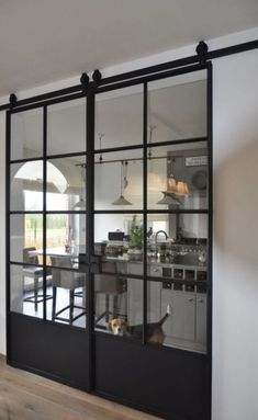 an open kitchen and dining room with sliding glass doors