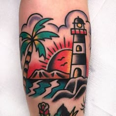 a tattoo with a lighthouse and palm trees on it