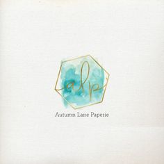 the logo for autumn lane paperie is shown in gold and blue watercolors